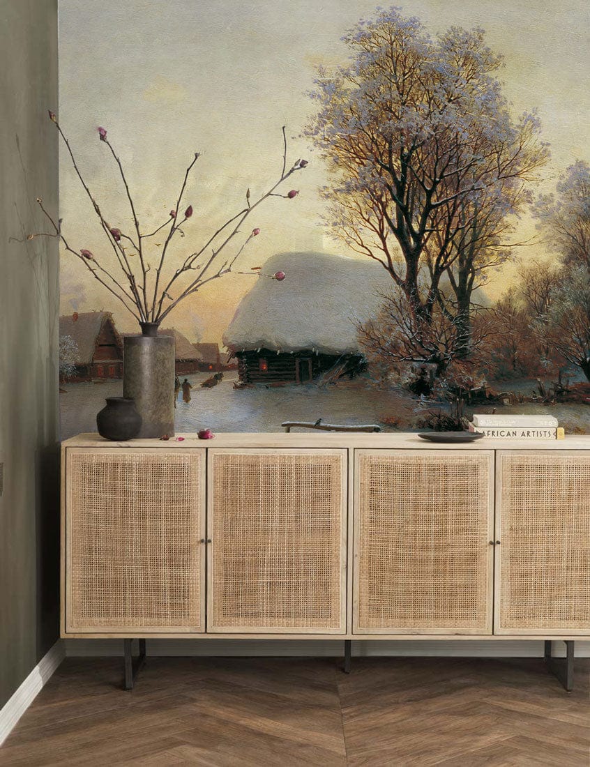 Tranquil winter landscape mural wallpaper in bedroom with neutral tones, wooden cabinet, herringbone flooring.
