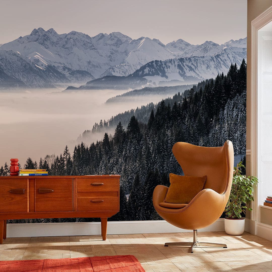 Serene snowy mountains mural wallpaper in living room with modern armchair, wooden cabinet, stylish decor.