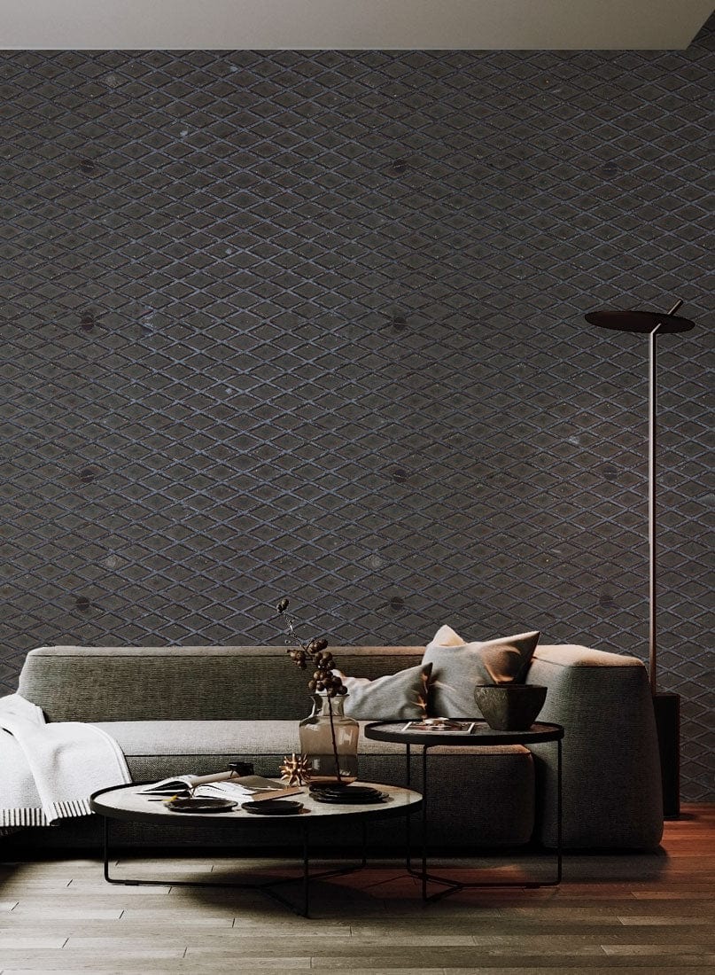 Contemporary grey sofa, geometric wall pattern, wooden flooring, modern floor lamp, stylish living room design.