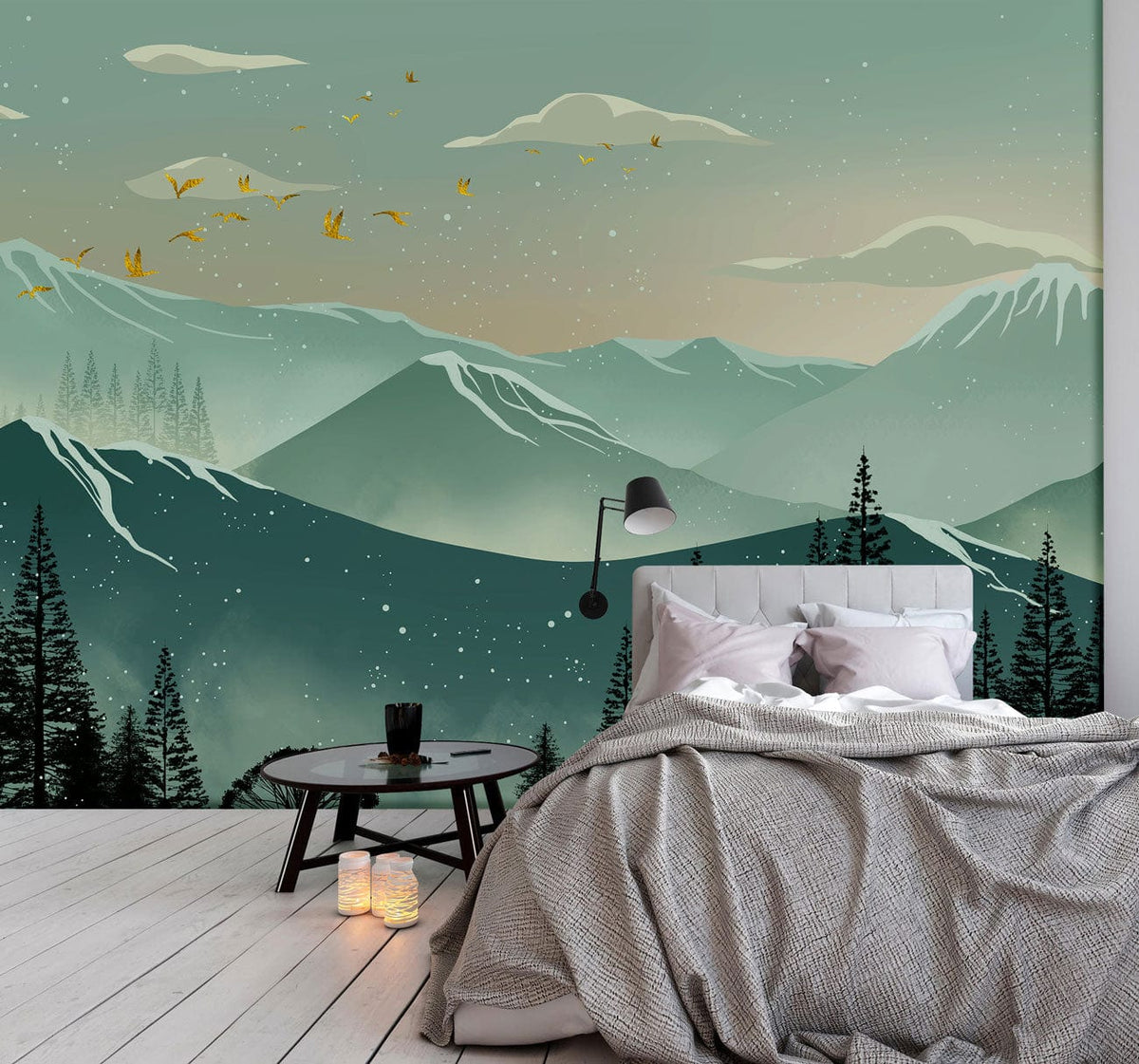 Teal and green mountain mural wallpaper, bed with grey bedding, cosy bedroom, light wood flooring.