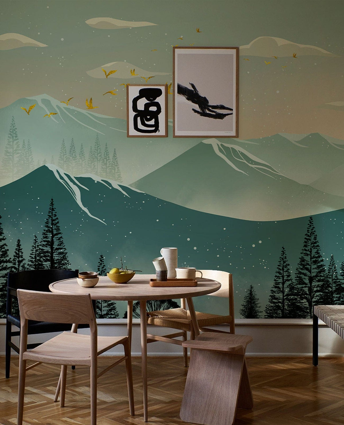 Teal mountain mural wallpaper, dining table, chairs, art frames, wooden parquet floor, serene decor.