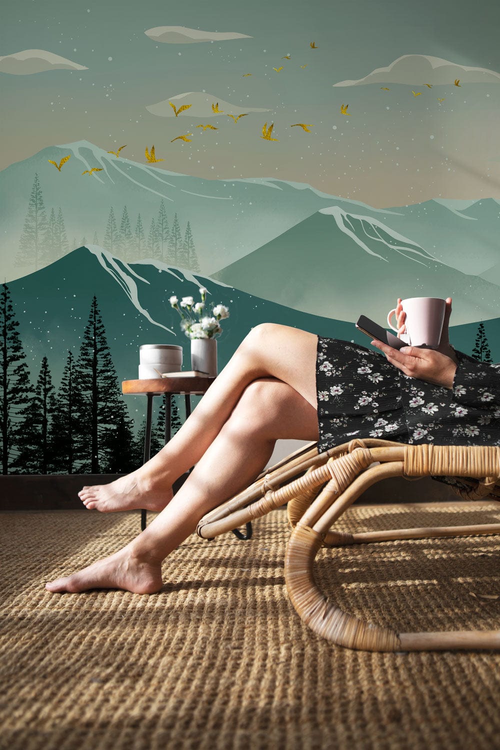 Serene Mountain mural in teal, wicker lounger, natural rug, person relaxing, contemporary room setting.