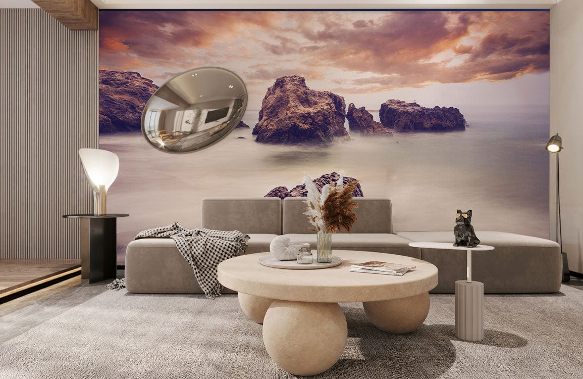 Serene coastal sunset mural wallpaper in a modern living room with grey sofa and soft lighting.