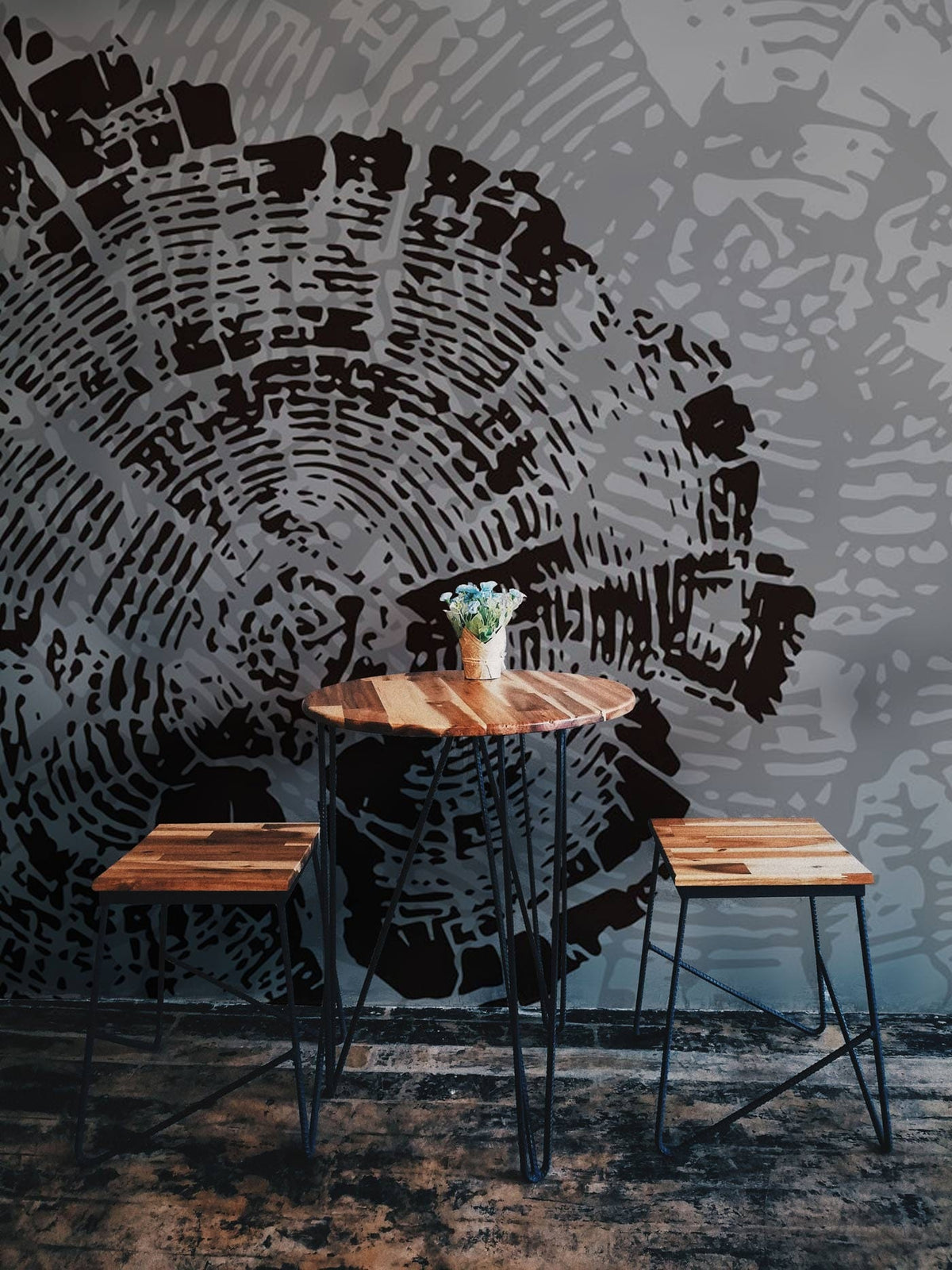 Grey and Black Tree Rings mural wallpaper with rustic wooden table and stools on dark flooring.