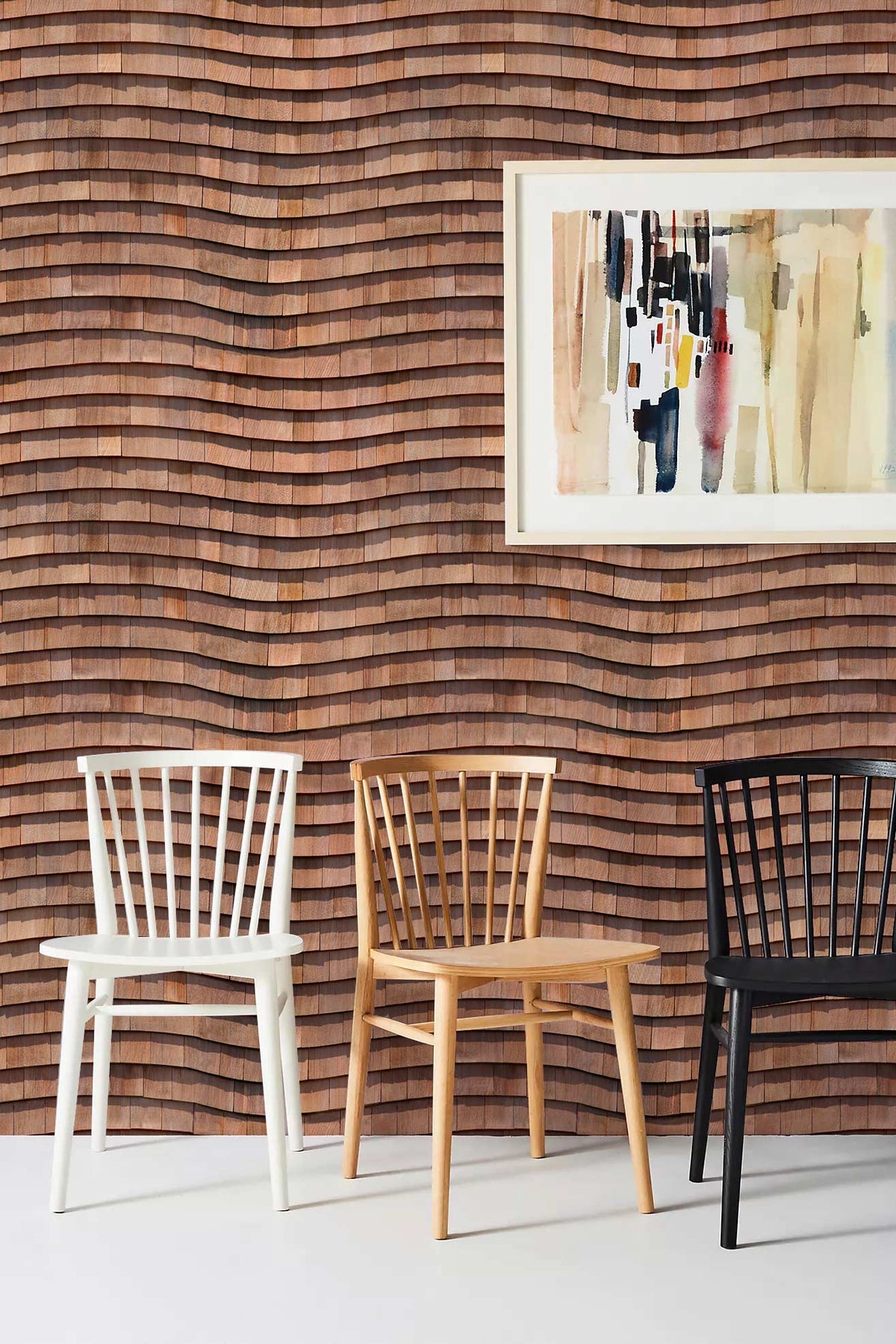 Rustic wood-effect wave pattern wallpaper with abstract artwork; white, natural, black chairs on white floor.