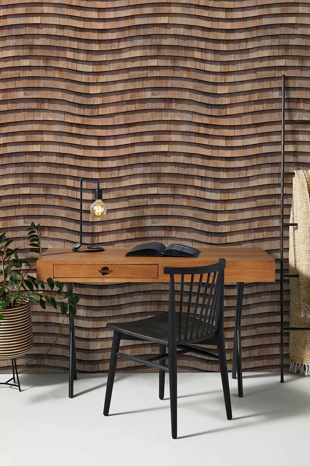 Rustic wood-effect wallpaper with wave pattern, wooden desk, black chair, earthy tones, home office decor.