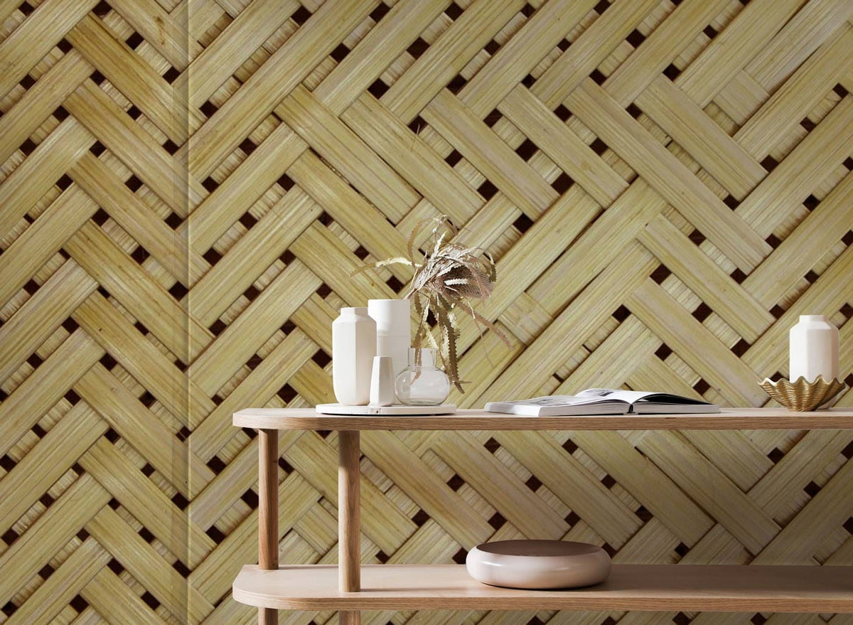Natural bamboo wallpaper in beige, woven pattern behind minimalist wooden table in rustic decor setting.