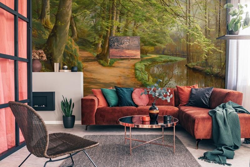 Tranquil riverside woodland path mural in living room with rust sofa, fireplace, modern decor, and rug.
