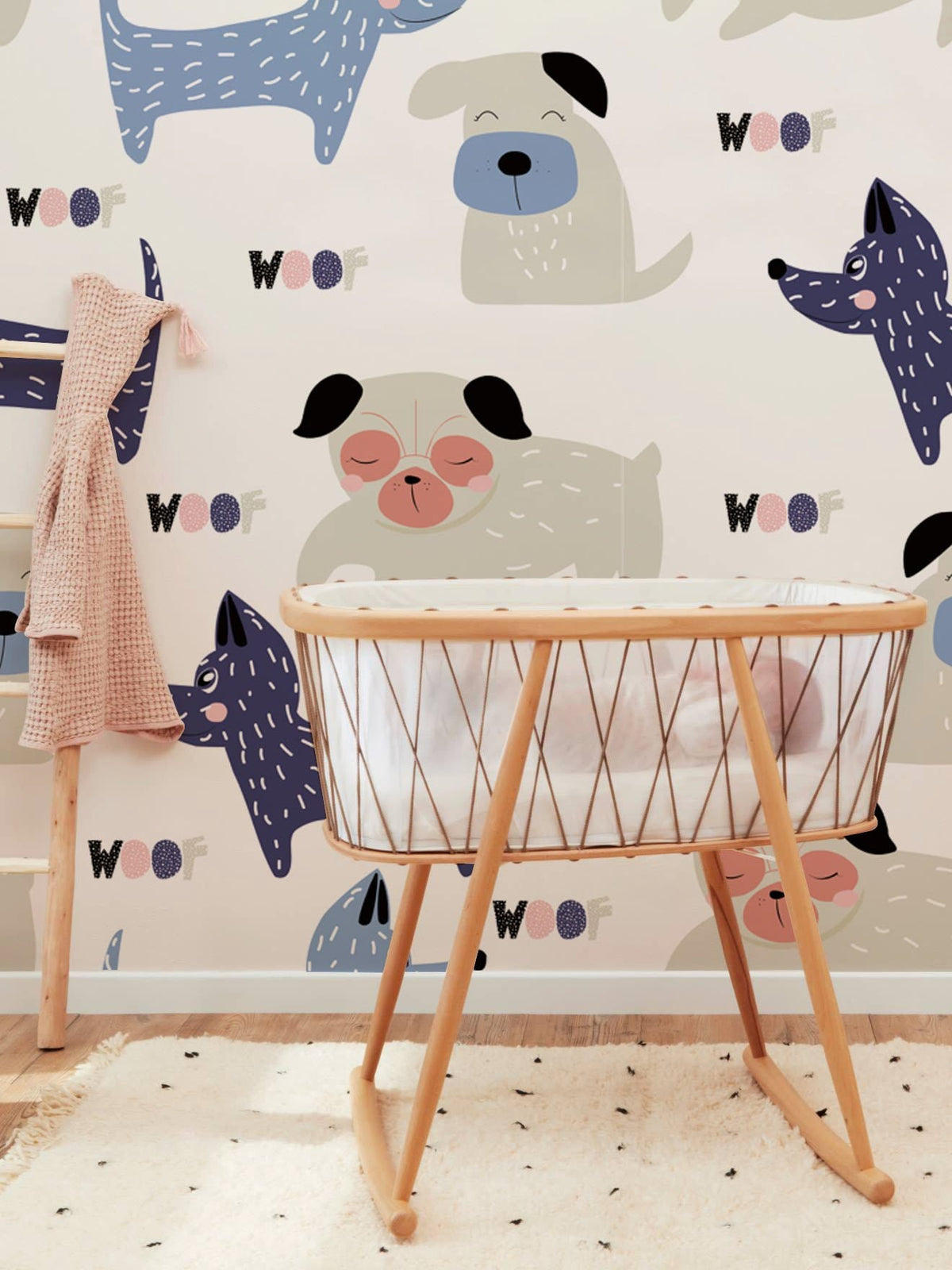 Playful pastel canine wallpaper in kids' room with wooden cradle and patterned rug for decor.