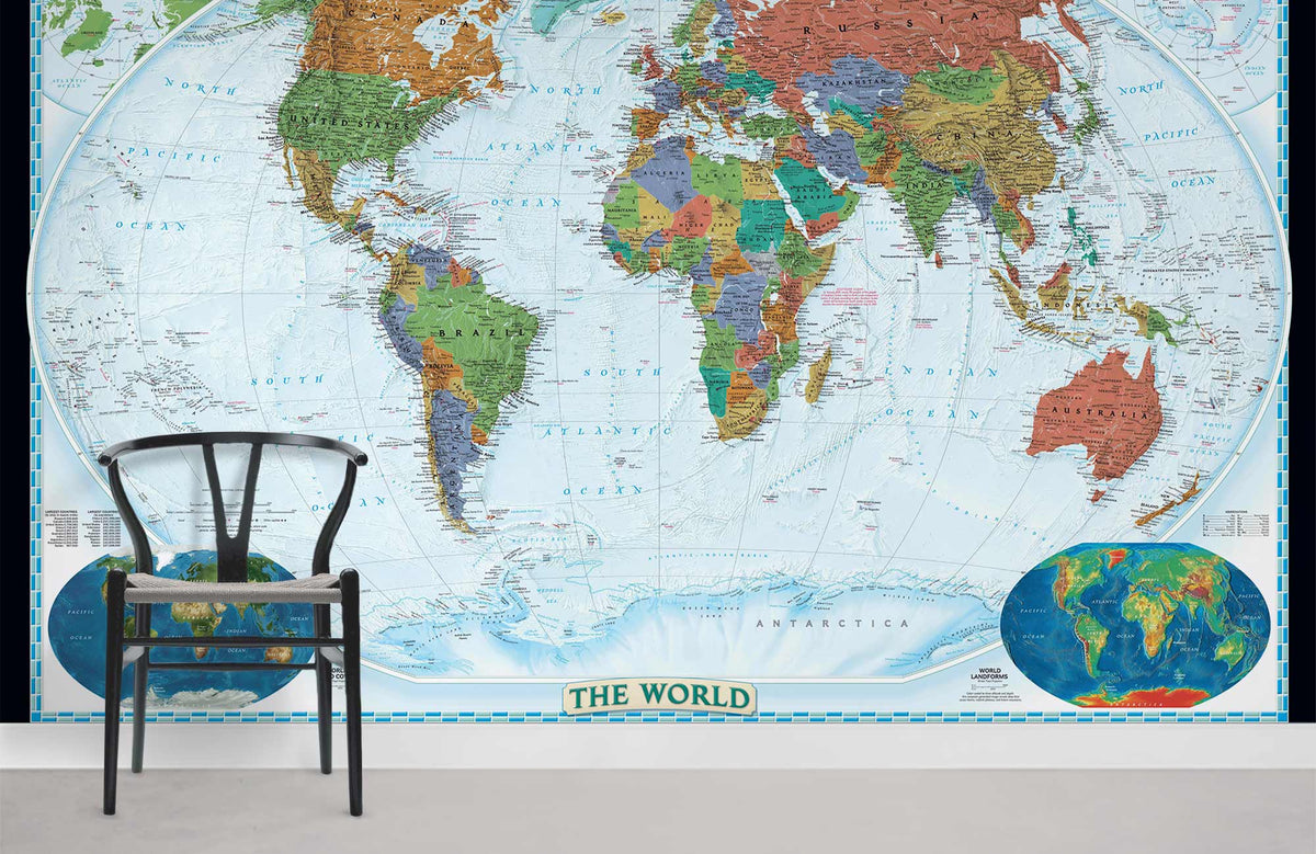 Vintage world map mural wallpaper with chair; classic blue, earth tones; minimalist room decor.