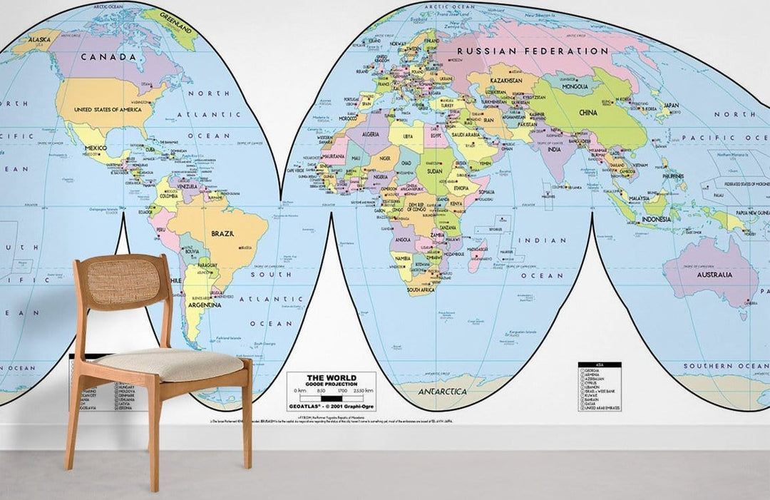 Colourful Vintage World Map Mural Wallpaper in educational room with wooden chair and white wall.