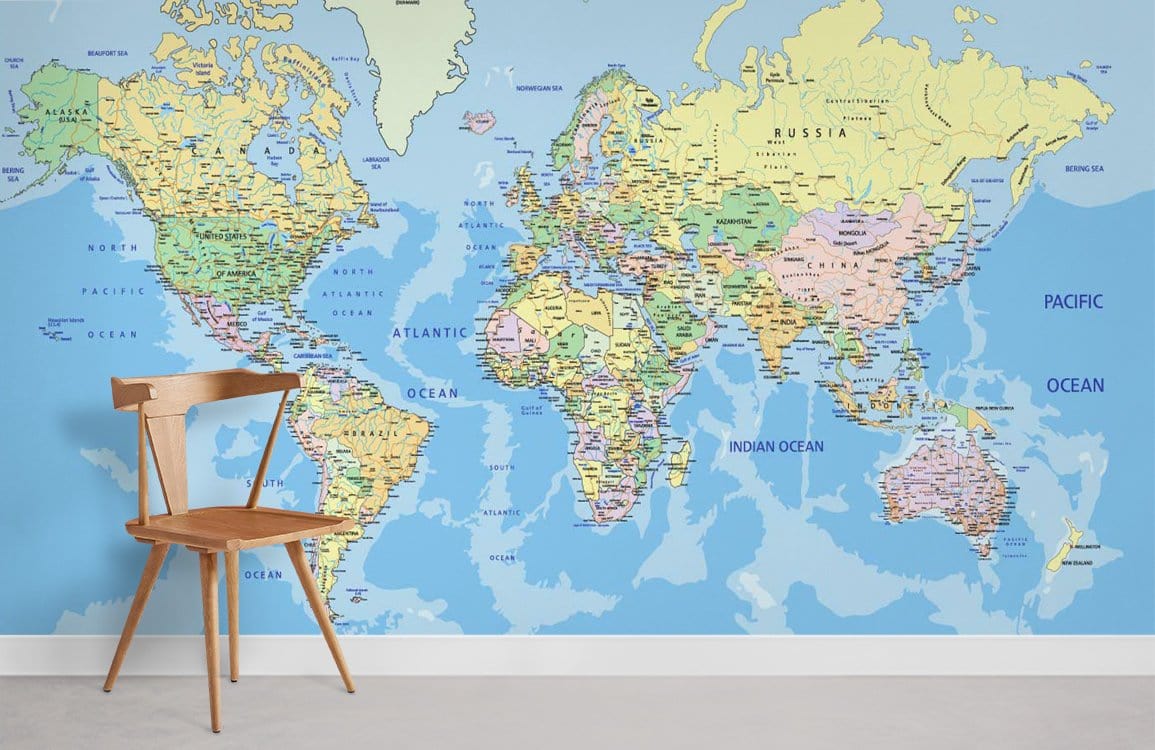 Blue Earth Tones World Map Mural Wallpaper in room with wooden chair, grey carpet flooring.