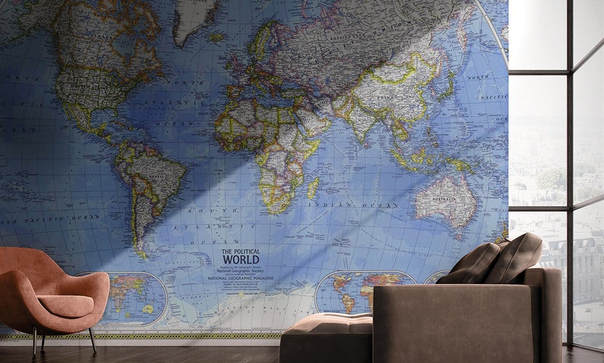 Vintage Blue World Map Mural Wallpaper with brown armchair, grey sofa, and modern living room decor.