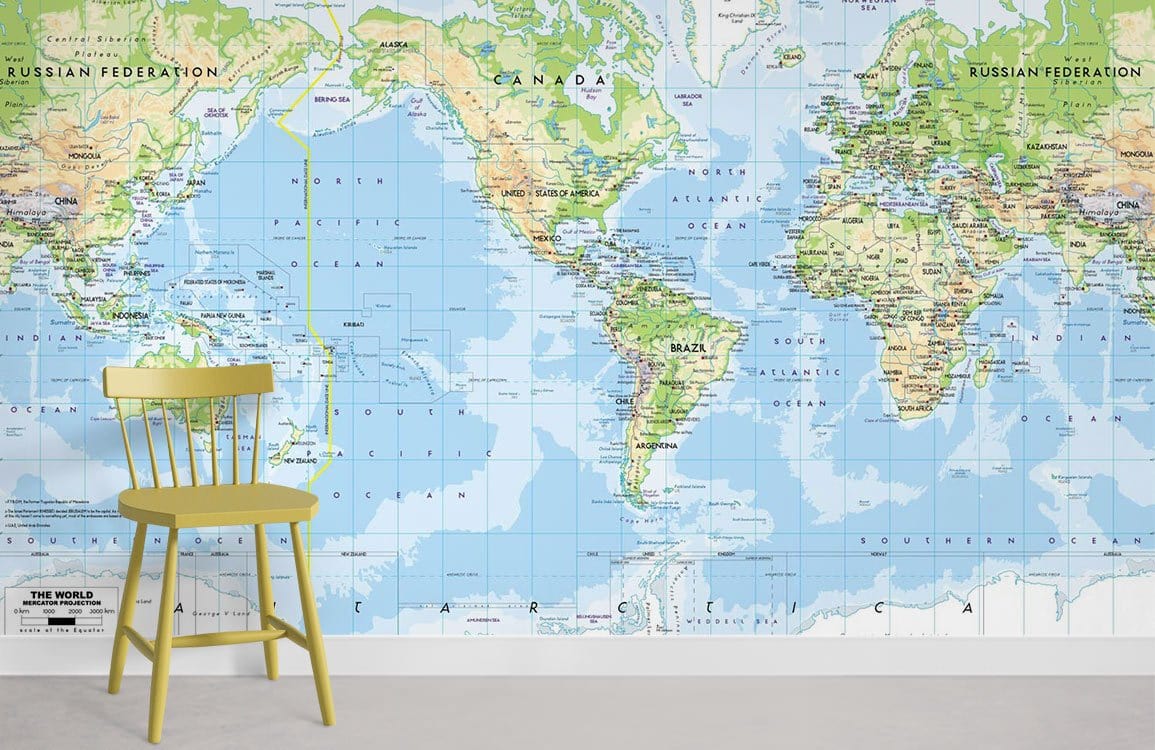 World Map Blue Green Mural Wallpaper in office setting, featuring yellow wooden chair and white wall.