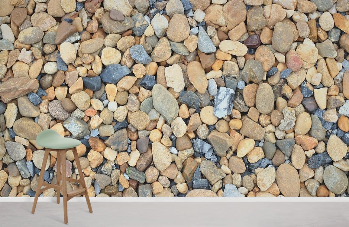 Natural Pebble Stone Texture Wallpaper in rustic grey, earth tones, complements modern stool on wood flooring.