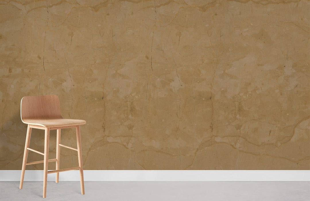 Elegant beige marble-effect wallpaper with wooden stool, complementing light grey flooring in a minimalist interior.