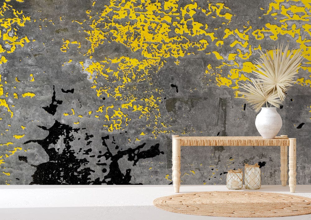Urban industrial graffiti wall mural in yellow and grey, wicker console table, round jute rug.