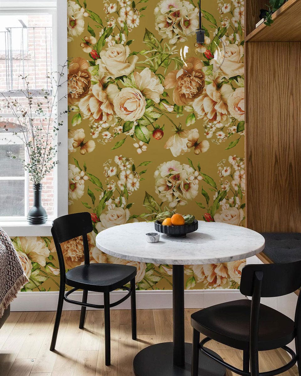 Beige and green floral mural wallpaper in dining room with modern round table, black chairs, wooden flooring.