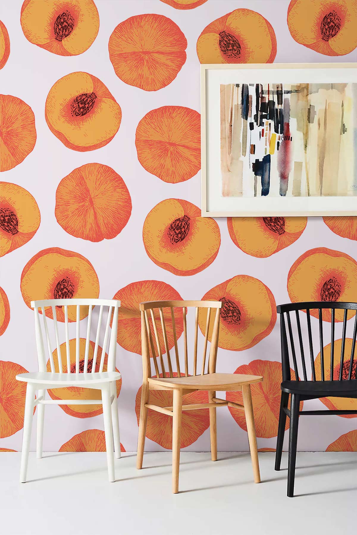 Alt text: Vibrant peach pattern wallpaper with abstract art, white floor, white, wooden, black chairs included.
