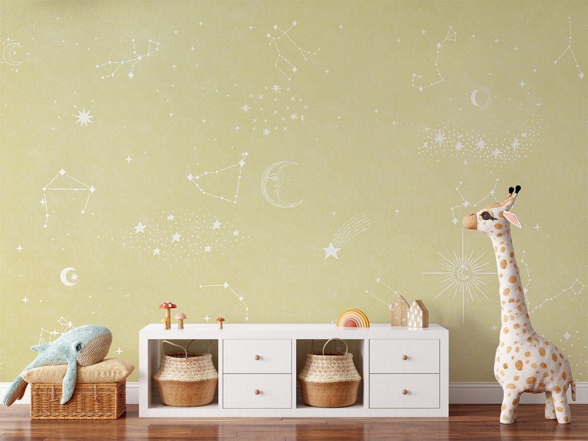 Celestial Dreams beige constellation mural decor with wooden flooring, white shelf, giraffe toy in nursery.