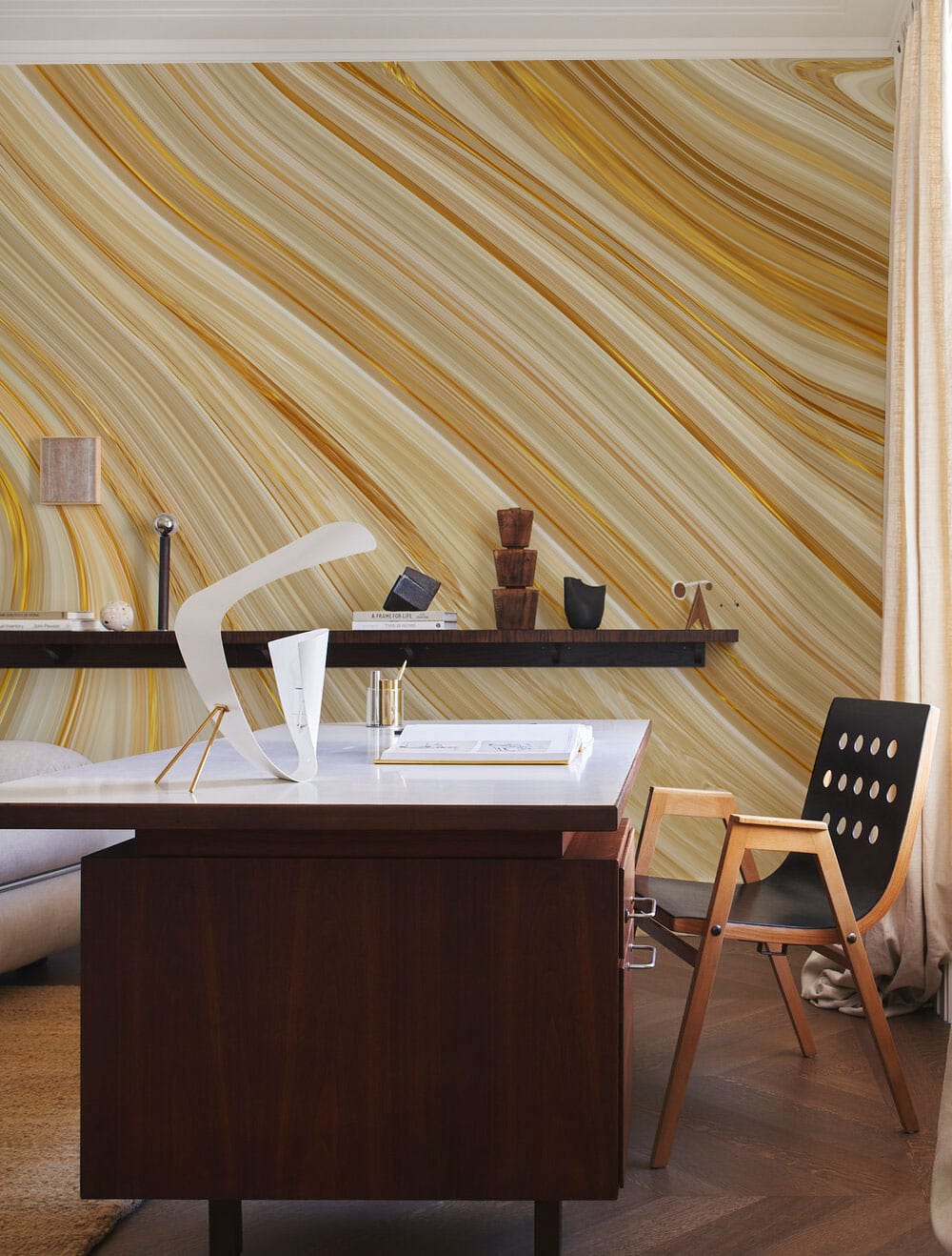 Elegant golden marble swirl wallpaper in modern office with wooden desk, black chair, and neutral flooring.
