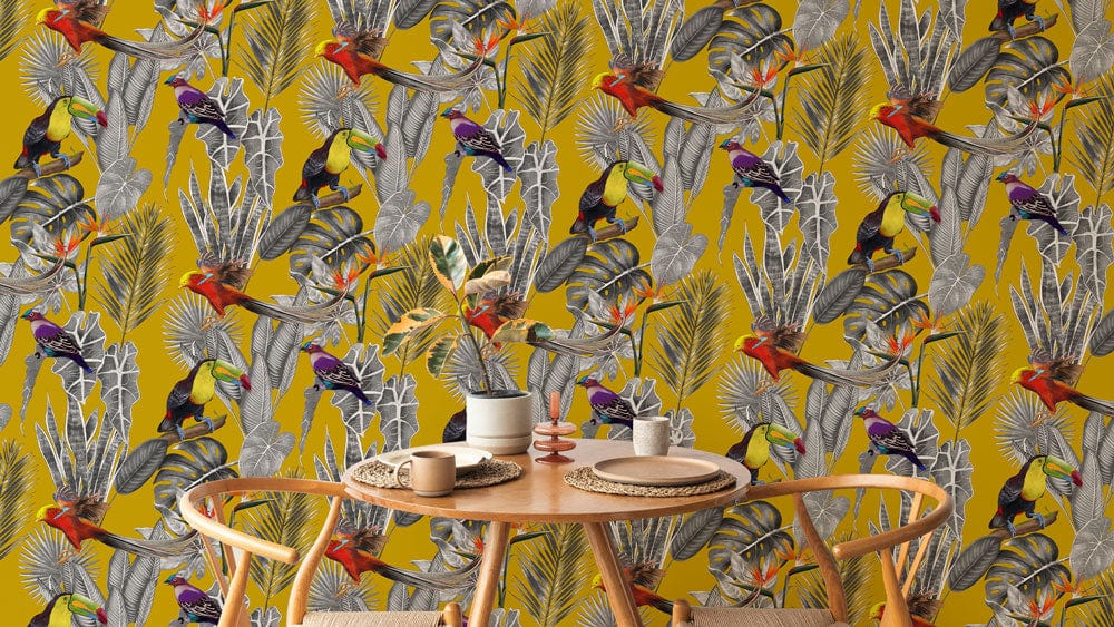 Mustard yellow tropical wallpaper with toucans behind wooden dining set in room setting.