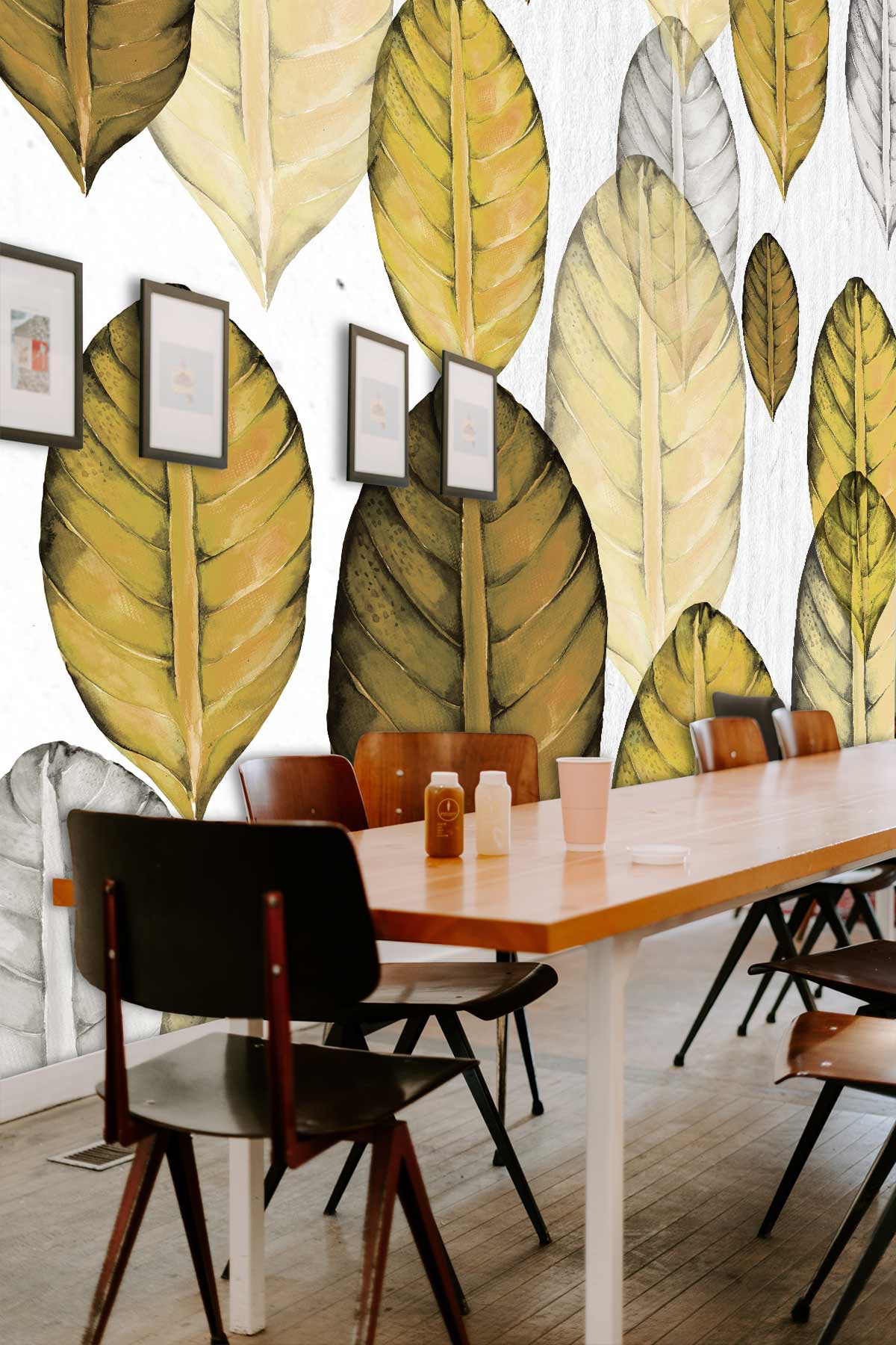 Autumnal leaf-patterned wallpaper, earthy tones; contemporary dining area, wooden table, dark chairs, framed art.